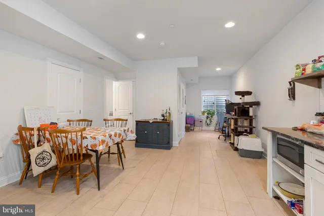 a living room with furniture a dining table and chairs with wooden floor