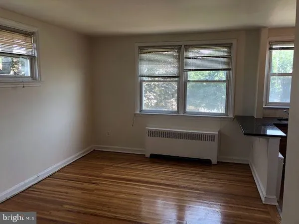 a room with wooden floor and a window