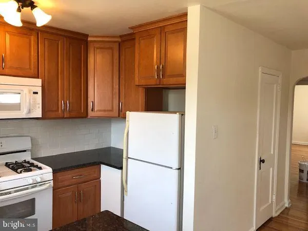 a white refrigerator freezer sitting in a kitchen