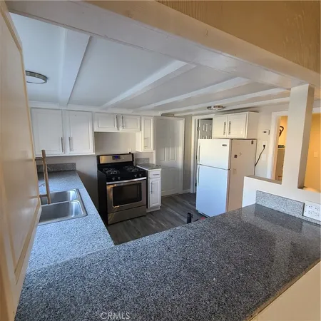 a kitchen with refrigerator and microwave