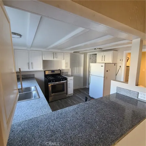 a kitchen with refrigerator and microwave