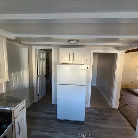 a view of a kitchen from a hallway