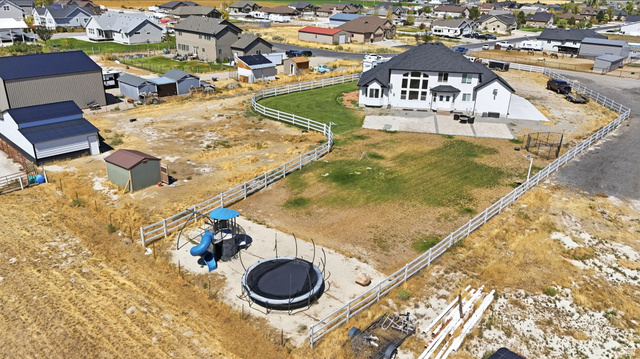 3644 Spiral Springs Road Tooele, UT 84074 - Photo 33 of 41 White exterior with multiple large windows and a dark roof