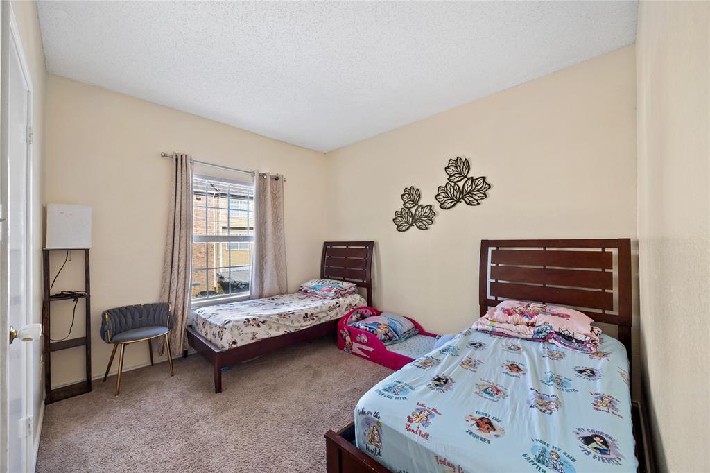 4115 Esters Road, Unit 710 Irving, TX 75038 - Photo 12 of 14 a bedroom with two beds and a window