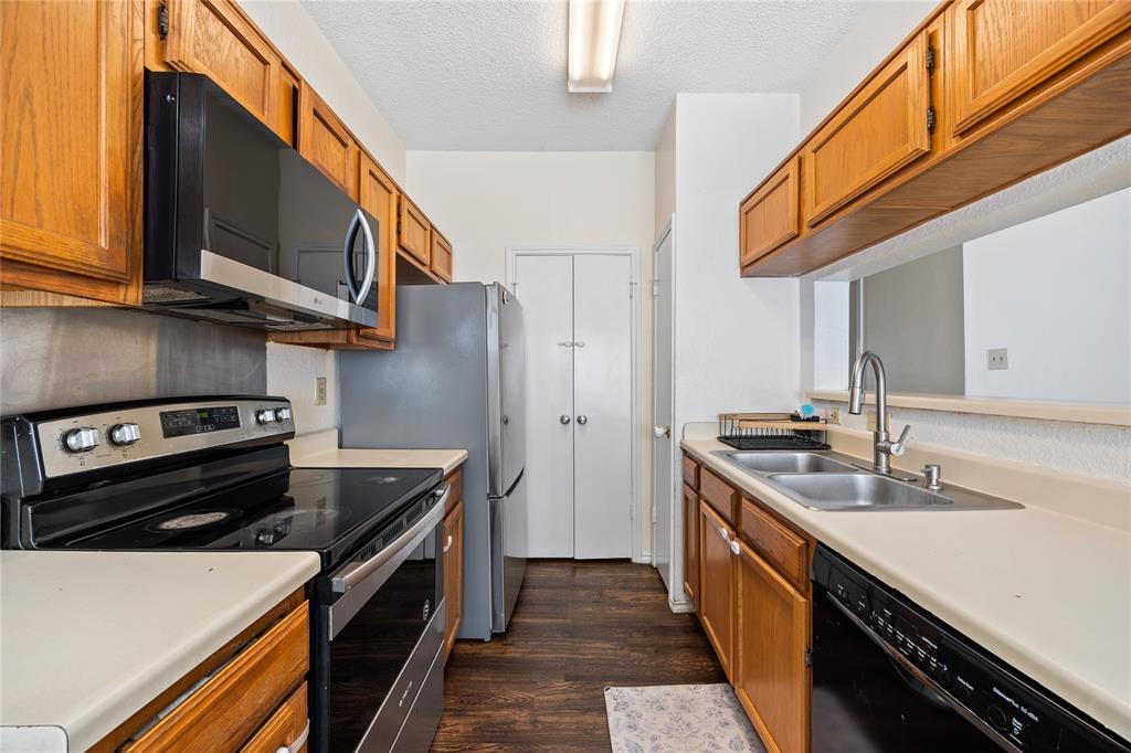 4115 Esters Road, Unit 710 Irving, TX 75038 - Photo 7 of 14 a kitchen with a stove and a sink