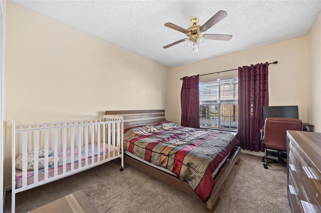 4115 Esters Road, Unit 710 Irving, TX 75038 - Photo 9 of 14 a bedroom with a bed and a ceiling fan