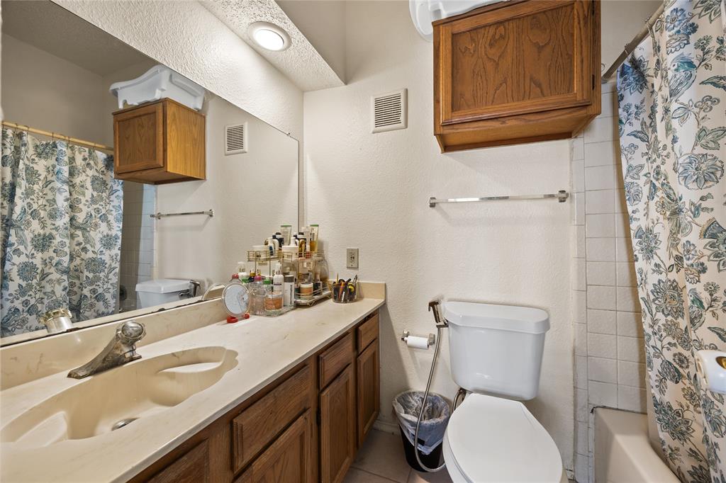 4115 Esters Road, Unit 710 Irving, TX 75038 - Photo 10 of 14 a bathroom with a sink vanity mirror and toilet