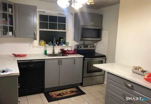 a kitchen with a sink appliances and cabinets