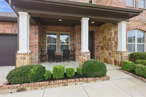 a front view of a house with outdoor seating and plants
