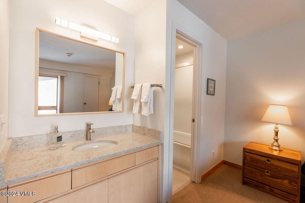 993 Lions Ridge Loop, Unit 343 Vail, CO 81657 - Photo 8 of 15 a bathroom with a sink vanity and a mirror