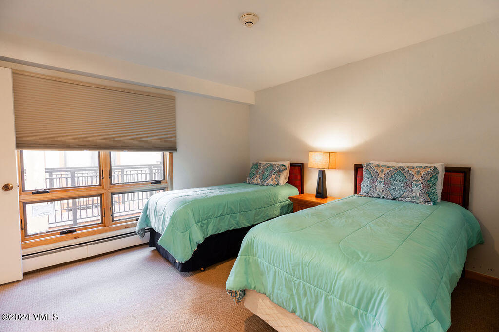 993 Lions Ridge Loop, Unit 343 Vail, CO 81657 - Photo 10 of 15 a bedroom with two beds and a large window