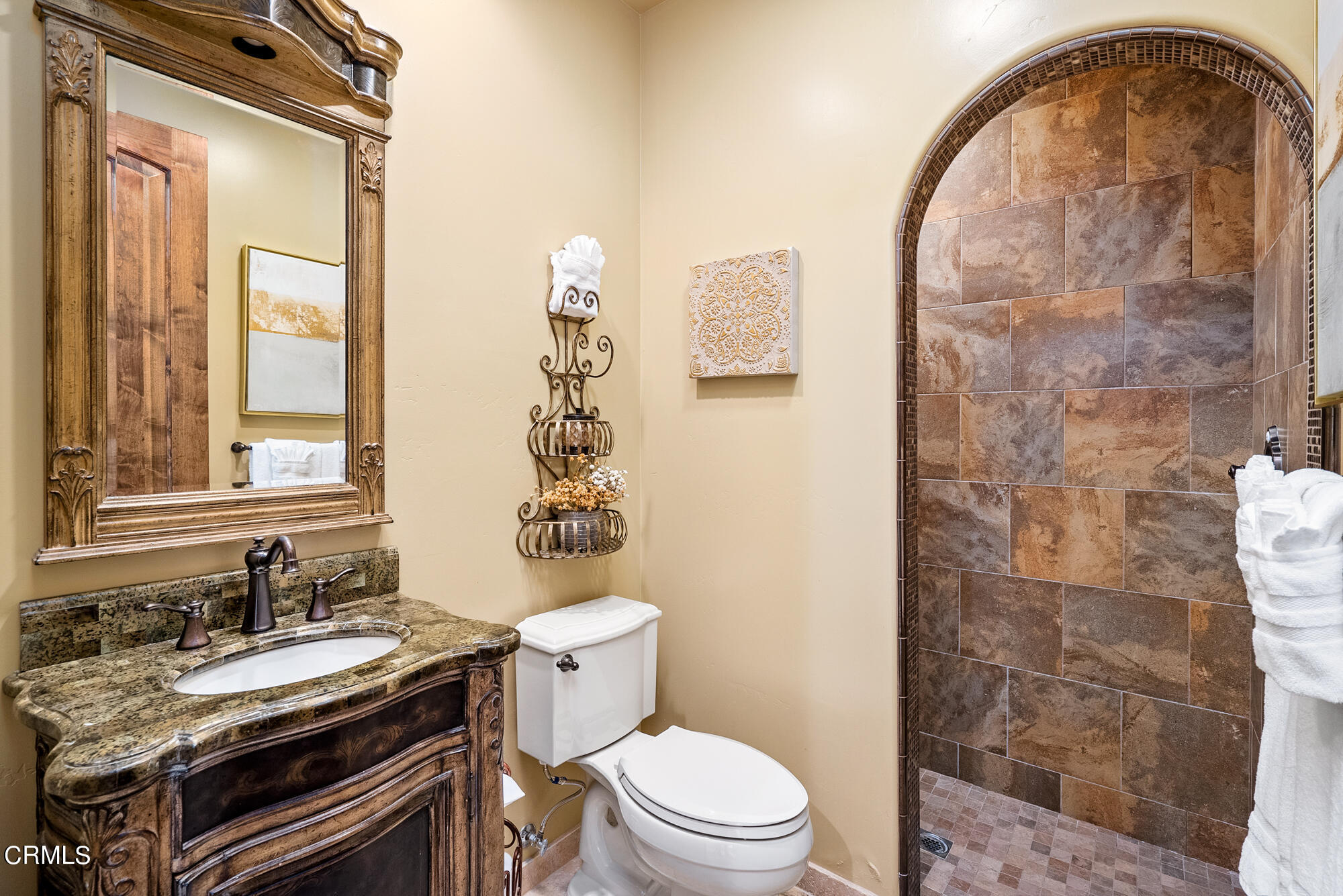 6060 Jardine Road Paso Robles, CA 93446 - Photo 35 of 74 a bathroom with a granite countertop toilet a sink and a mirror