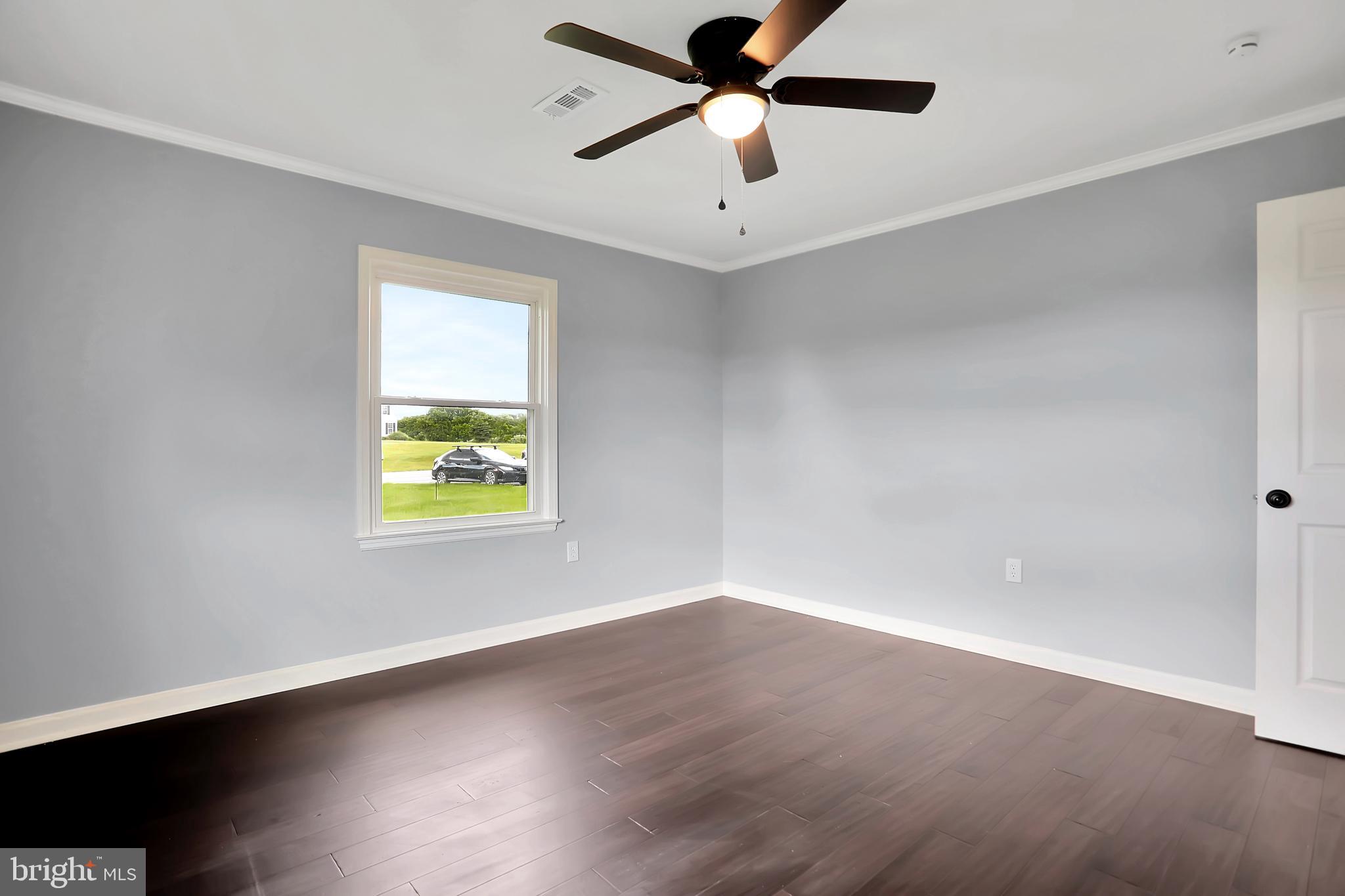 3192 Old Leetown Pike Ranson, WV 25438 - Photo 27 of 50 an empty room with a window and ceiling fan