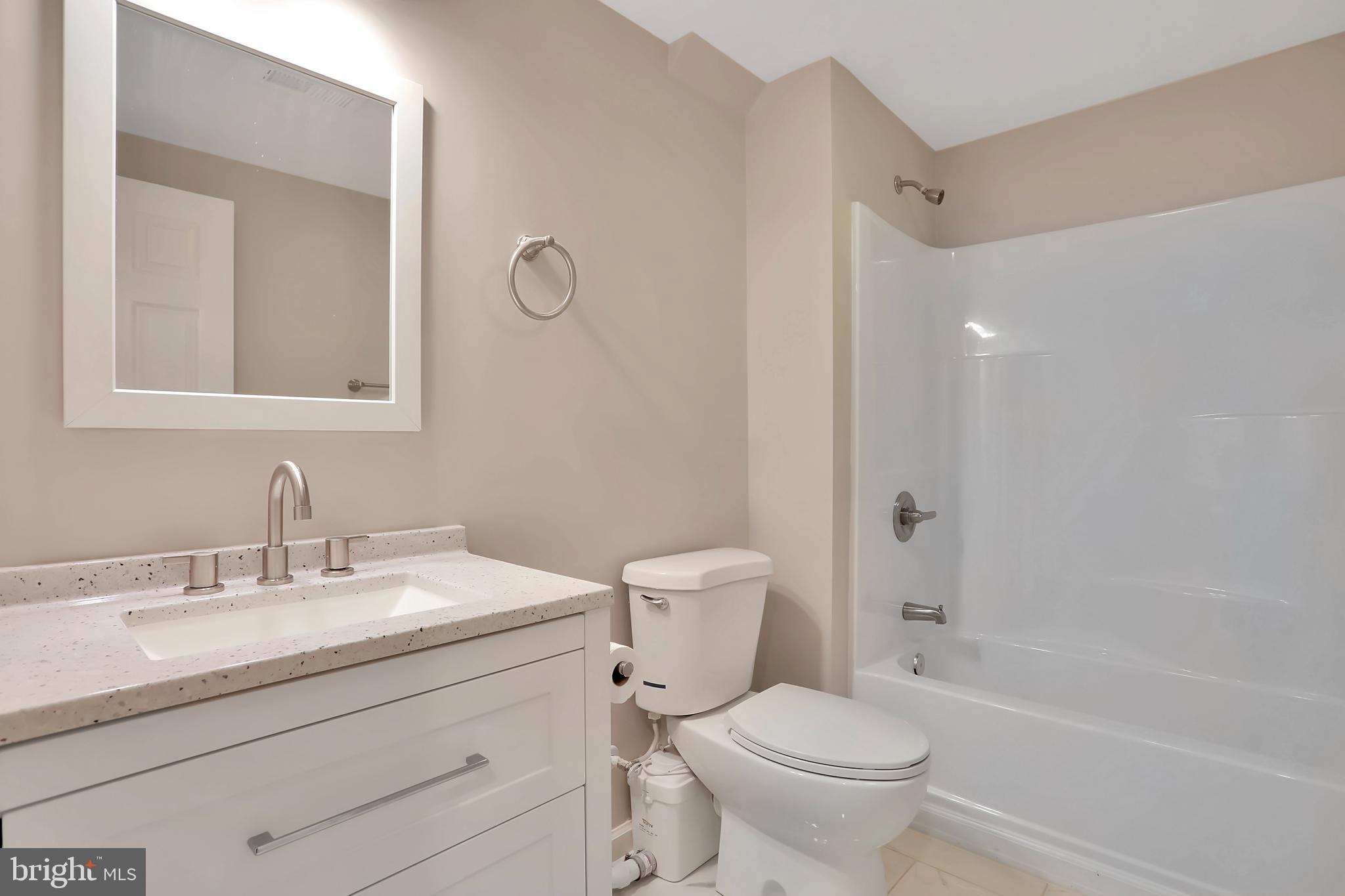 3192 Old Leetown Pike Ranson, WV 25438 - Photo 33 of 50 a bathroom with a toilet a sink a mirror a bathtub and vanity