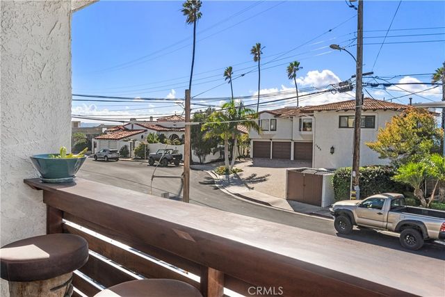 a roof deck with couches and potted plants