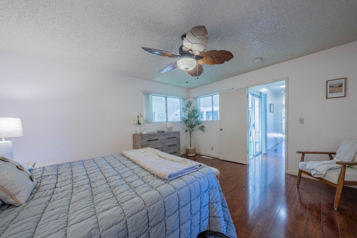 9525 South Century Oak Road Salinas, CA 93907 - Photo 25 of 37 a spacious bedroom with a bed and a chandelier
