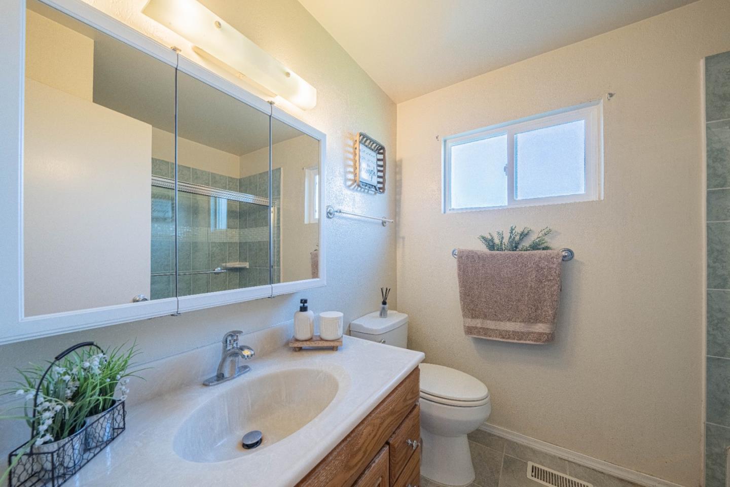 9525 South Century Oak Road Salinas, CA 93907 - Photo 30 of 37 a bathroom with a sink a toilet and mirror