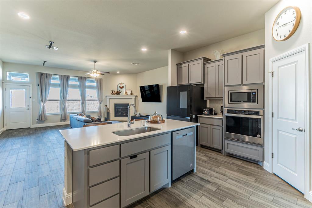 10638 Cherry Tree Way Grand Prairie, TX 76065 - Photo 8 of 39 Another view of the kitchen featuring stainless steel appliances and large island