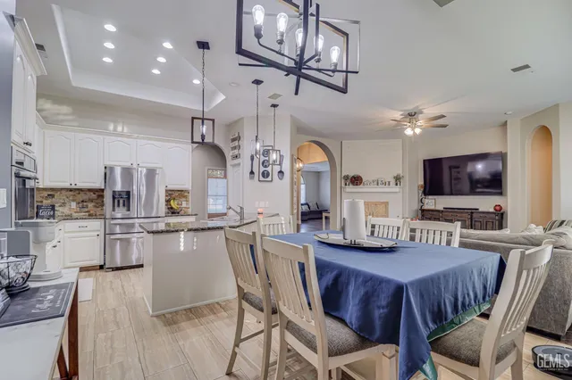 a view of a dining room with furniture and a chandelier