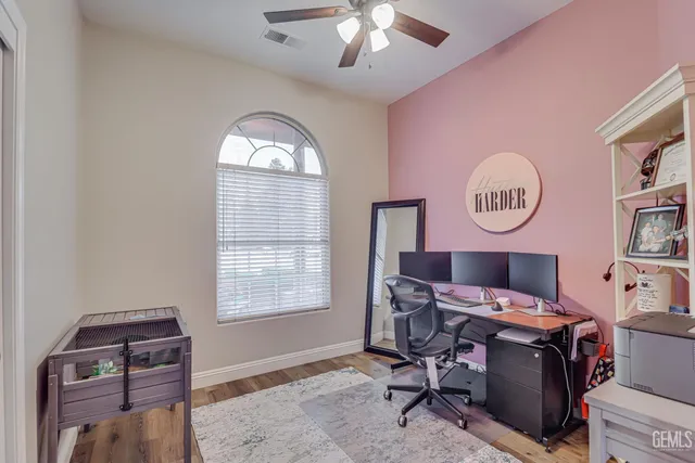 a view of a livingroom with workspace and a window