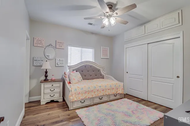 a bedroom with a large bed and a chandelier