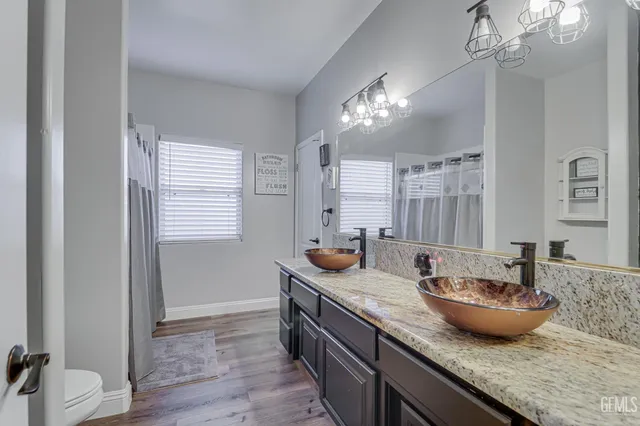 a view of a kitchen area with granite countertop furniture and wooden floor