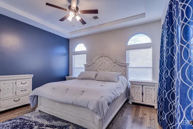 a bedroom with a bed and a chandelier