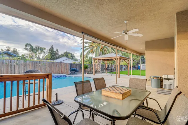 a view of a patio with a dining table and chairs