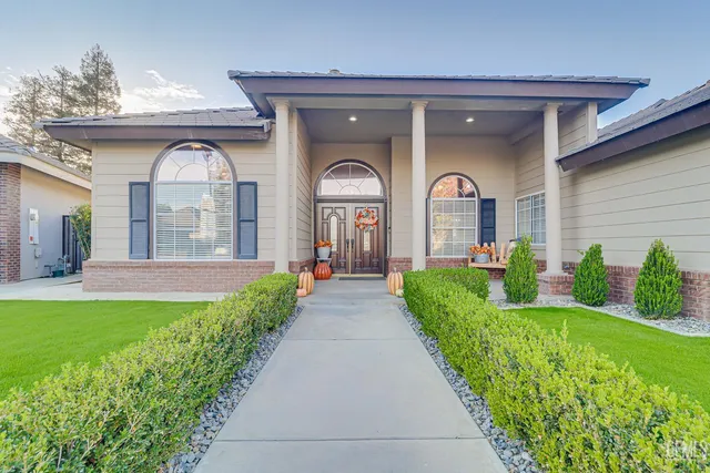 a front view of a house with garden