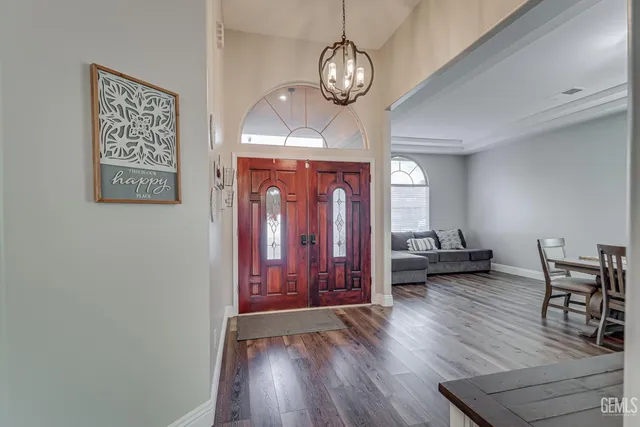 a view of a room with furniture and wooden floor