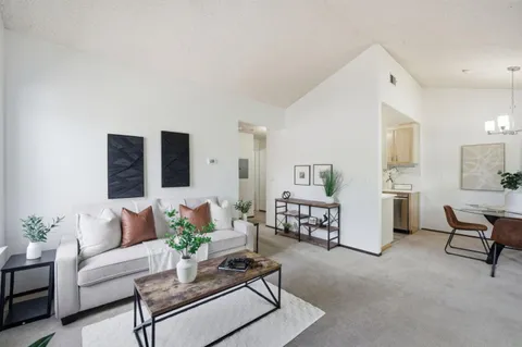 a living room with furniture and a table