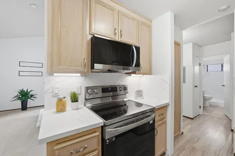 a kitchen with a sink a stove and cabinets