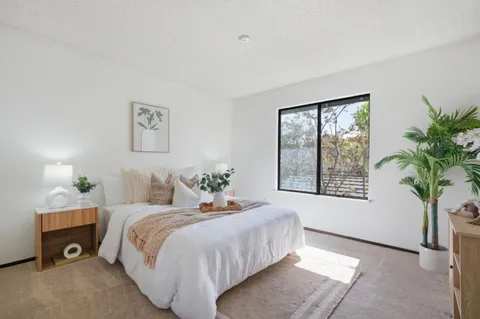 a bedroom with a bed and a window