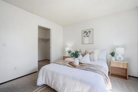a bedroom with a bed and a couch