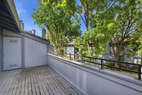 a view of a balcony with a tree