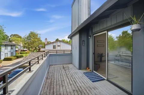 a view of balcony with wooden floor