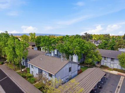 an aerial view of a house with a yard