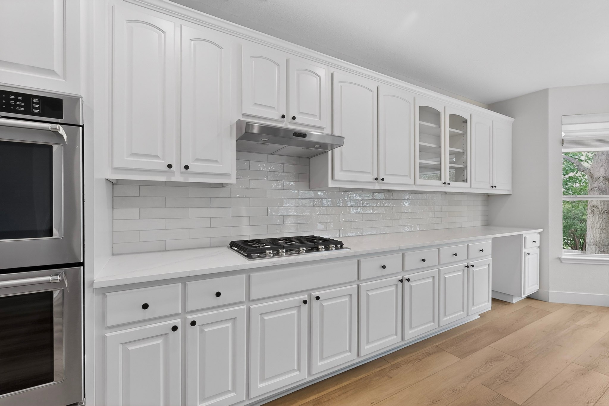 8617 Cobblestone Austin, TX 78735 - Photo 13 of 39 a kitchen with white cabinets and a stove