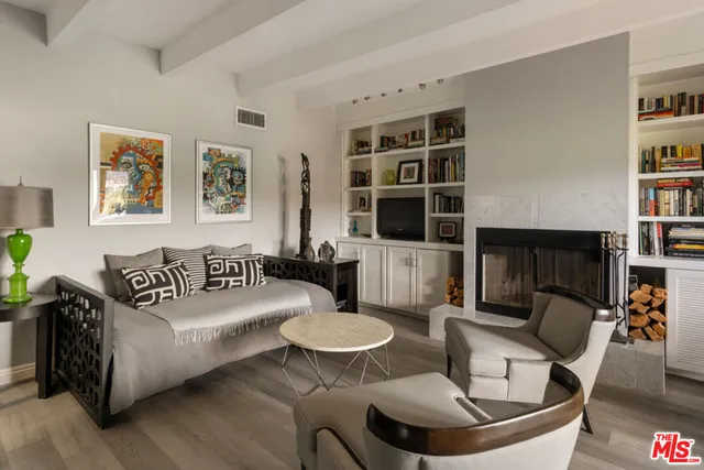 a living room with furniture and a book shelf