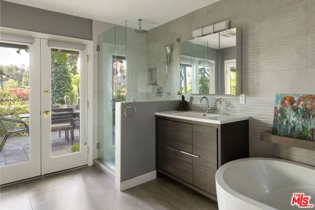 a bathroom with a tub sink and mirror