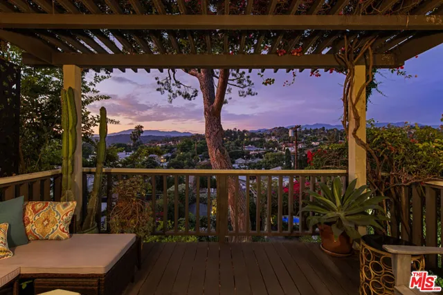 a view of an outdoor space with seating area and trees
