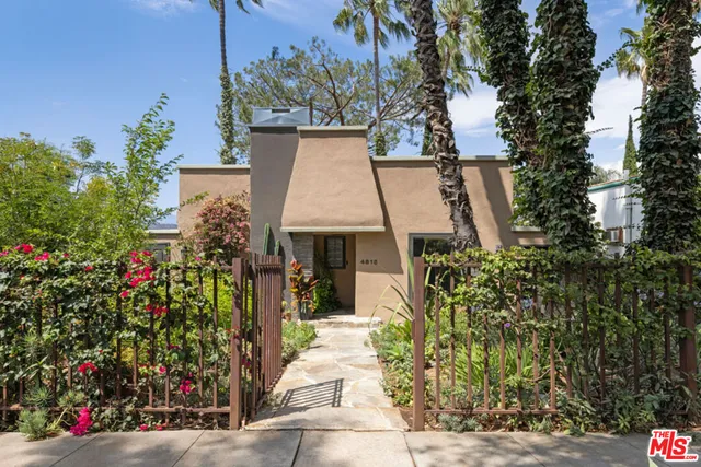 an aerial view of a house with a yard and garden