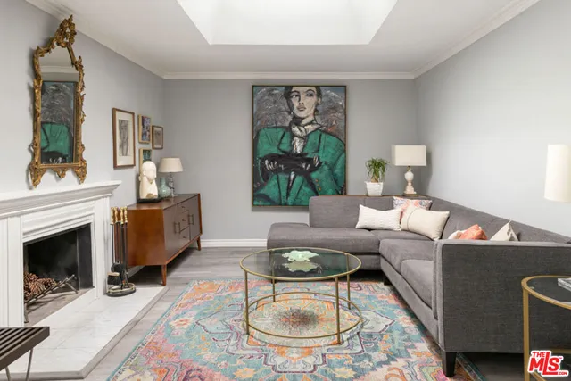 a living room with furniture a rug and a fireplace