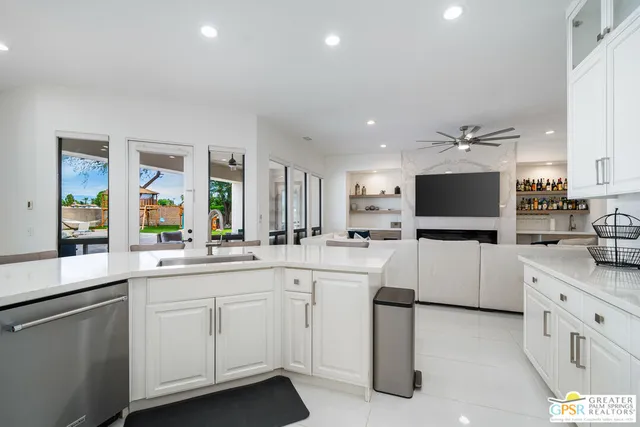 a kitchen with sink cabinets and white appliances