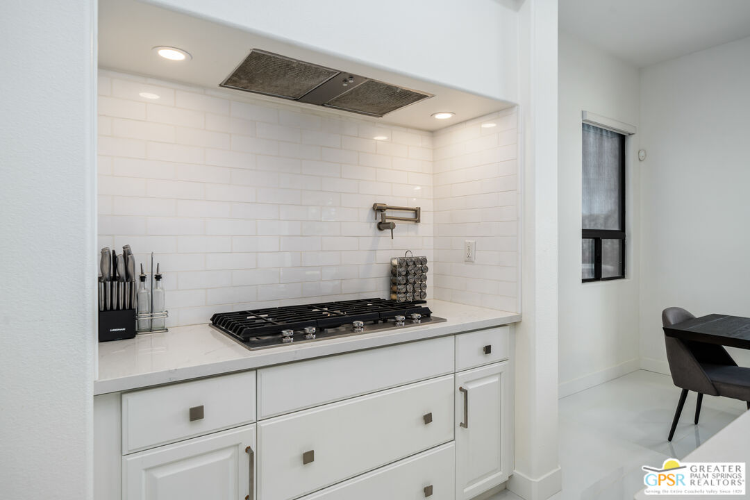 74226 Via Venezia Palm Desert, CA 92260 - Photo 16 of 38 a kitchen with white cabinets and a stove
