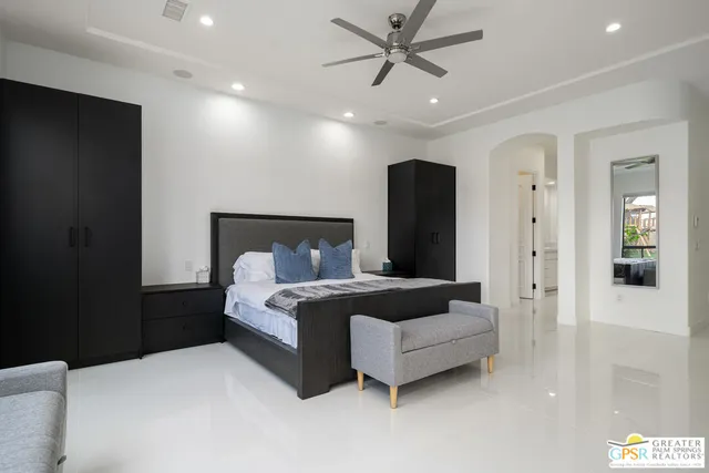 a spacious bathroom with a double vanity sink mirror and bathtub