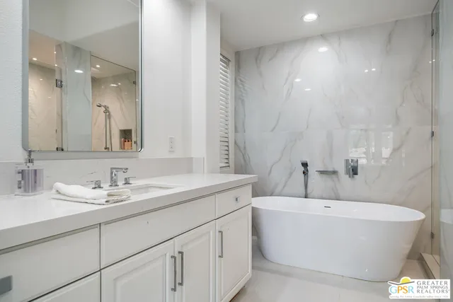 a bathroom with a bathtub and shower