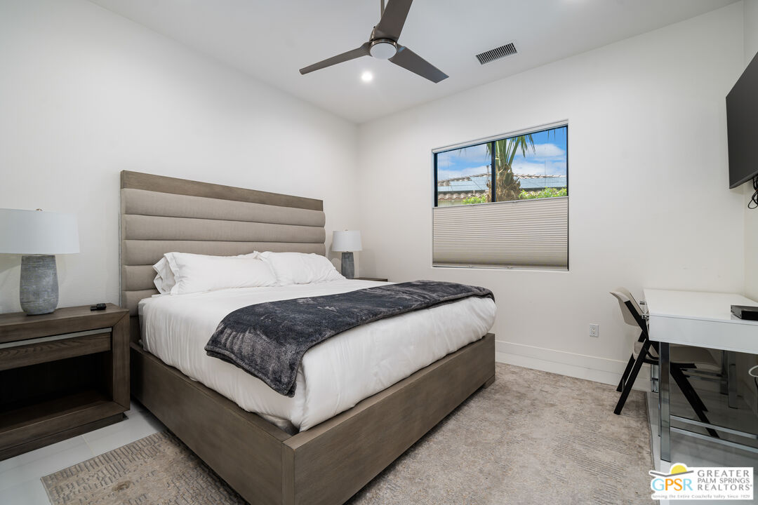 74226 Via Venezia Palm Desert, CA 92260 - Photo 23 of 38 a bedroom with a bed and a chair