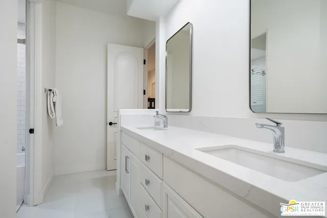 a bathroom with a toilet a sink and a mirror
