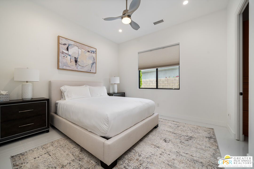 74226 Via Venezia Palm Desert, CA 92260 - Photo 27 of 38 a bedroom with a large bed and a window